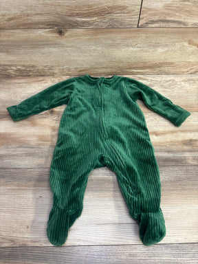 Green ribbed long-sleeve baby footed sleeper laid flat on wooden surface