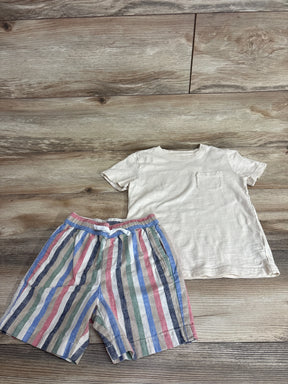 Flat lay of boys' cream slub pocket tee and linen-cotton multicolor striped shorts showing front view on wood floor