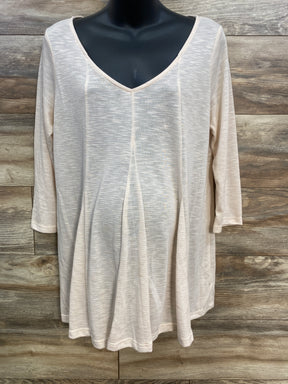 Light beige women's long-sleeve V-neck blouse displayed on black mannequin against wooden background