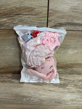 Pink baby plush octopus toy with textured blanket and teether in clear resealable bag on wooden surface