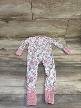 Front view of Angel Dear bamboo floral convertible zip sleeper in white with pink cuffs and foot coverings on a wood-look floor