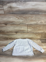 Light gray kids crewneck sweatshirt with cuffed sleeves, laid flat on wood floor