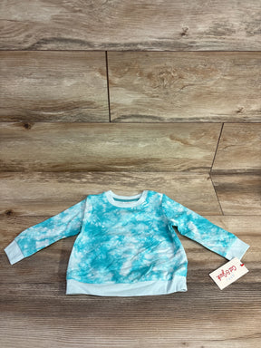 Blue tie-dye long sleeve baby sweatshirt with tag on wooden background