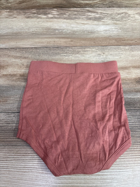 Dusty pink Kate Quinn bamboo bloomers for babies size 6-12m on a wood background