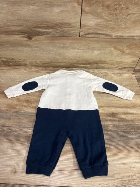 Back view of PatPat gentleman suit coverall with white top, navy lower half, and navy elbow patches on wood flooring
