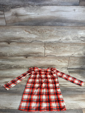 Red and white plaid long sleeve girls dress laid flat on wood floor