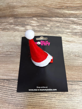 Red and white felt Santa hat hair clip for babies, festive holiday accessory on black card