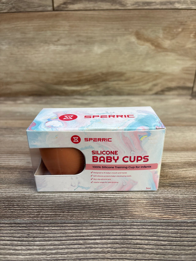 Front view of Sperric 3oz silicone baby cups 2-pack box showing one brown cup through window on a wood tabletop