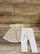 Front view of First Impressions knit dress and leggings set showcasing beige leopard print dress and white leggings on wood