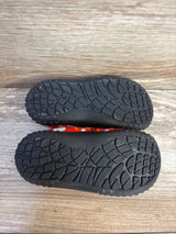 Top-down view of Disney Baby Mickey Mouse water shoes, size 7/8C, showing textured black non-slip soles on a wood surface