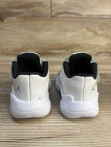 Rear view of white and black toddler sneakers with blue logo on wooden floor