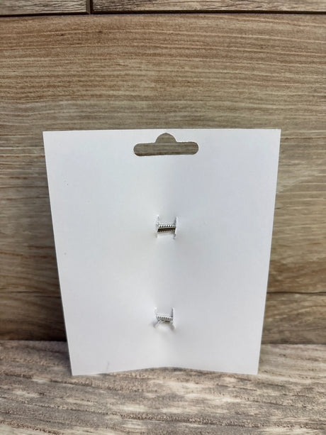 Front view of 2-pack hair bows display card showing two empty clip fastenings on a wood background