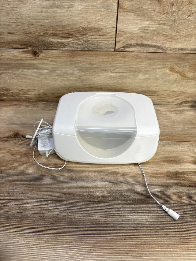 Front view of Munchkin Bright & Warm wipe warmer showcasing translucent flip lid and included power adapter on wooden tabletop background