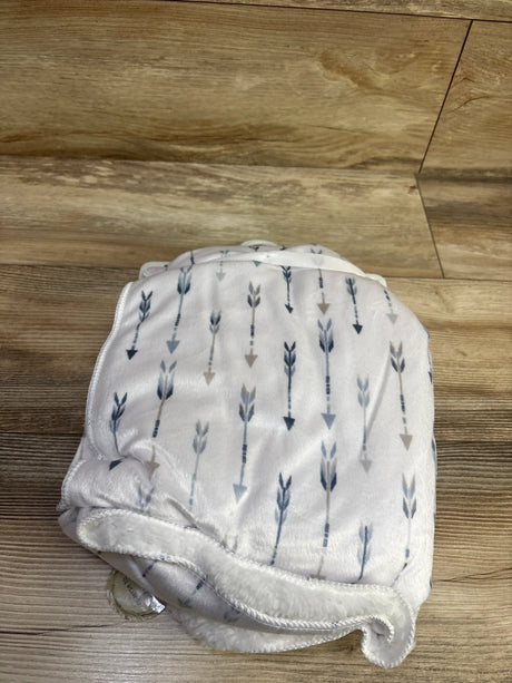 Folded view of 30 by 40 inch Quinn Arrow Blue reversible baby blanket showcasing blue and gray arrows on a wood floor