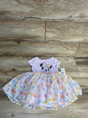 Pink Minnie Mouse toddler dress with pastel polka dots and tutu skirt on wood floor