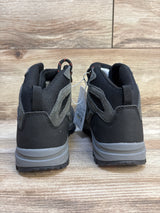 Rear view of kids' black and gray athletic sneakers on wood floor, resale condition