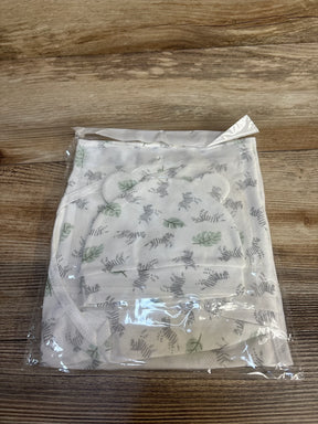 Top-down view of newborn swaddle wrap and matching hat showcasing green leaf print and ear-shaped detail on wooden surface