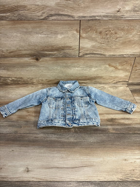 Light blue denim toddler jacket with buttons and chest pockets on wooden background