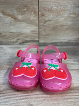 Front view of Cat & Jack pink jelly sandals size 5C with red cherry appliques on toes and adjustable straps on wood floor