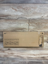 Unopened brown cardboard toy box with product warnings on wood floor, kids toy packaging
