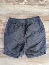 Back view of Old Navy grey toddler drawstring shorts showing elastic waistband and gathered leg hems on wood background