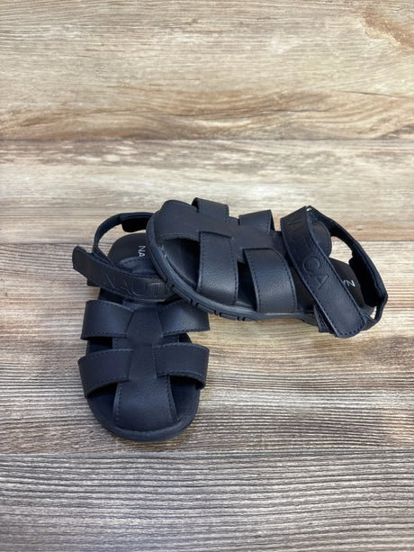 Top-down view of Nautica toddler fisherman sandals in navy showing woven straps and Velcro ankle strap on wood background