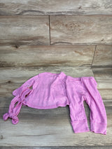 Flat lay of Cat & Jack hot pink infant ruffled long-sleeve top, matching pants, and knotted headband on wood floor