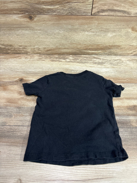 Back view of Carter’s Just Wanna Play black shirt in size 24 months showing a plain back on a wood-look floor