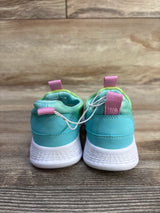 Rear view of Cat and Jack toddler slip-on sneakers with aqua upper, mint lining, pink heel tabs and white sole on wood floor