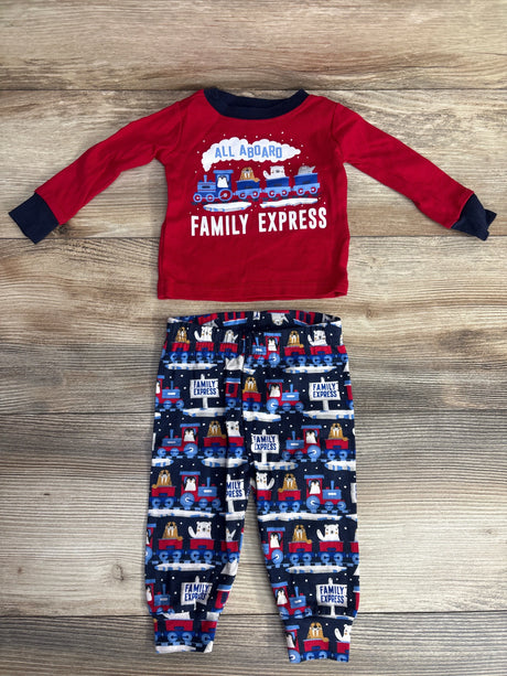 Red long-sleeve toddler shirt with train and animals, matching navy blue train-print pants on wood floor