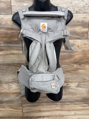 Gray Ergobaby baby carrier with waist pouch on black mannequin, wood background