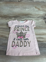 Flat-lay of pink girls' 3T short-sleeve t-shirt showcasing glitter text I found my prince I call him Daddy with crown and hearts on wood background