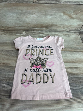 Flat-lay of pink girls' 3T short-sleeve t-shirt showcasing glitter text I found my prince I call him Daddy with crown and hearts on wood background