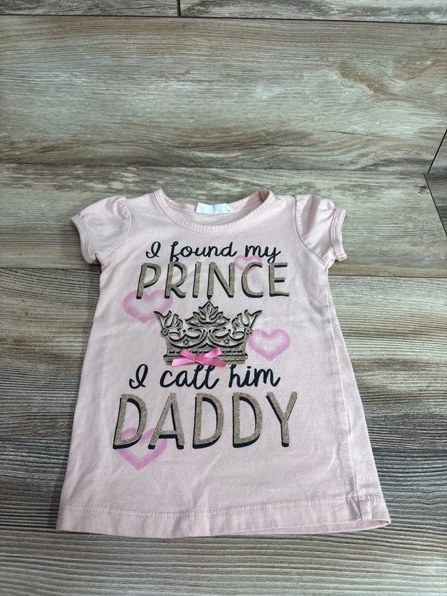 Flat-lay of pink girls' 3T short-sleeve t-shirt showcasing glitter text I found my prince I call him Daddy with crown and hearts on wood background