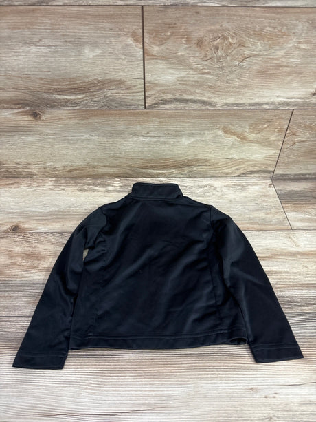 Back view of black Nike track jacket in size 2T showcasing long sleeves and stand collar on wood-look flooring