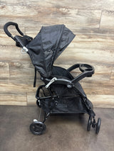 Front view of Kolcraft Cloud Premier stroller in black showing canopy, cup holder, and storage basket