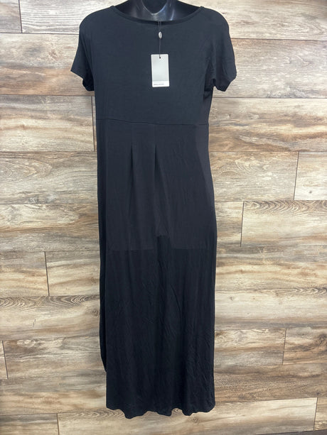 Front view of black Smallshow maternity nursing dress in size Medium, showcasing short sleeves and gathered skirt against a wood-look floor