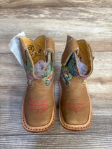 Kids brown leather cowboy boots with floral embroidery and pink stitching, on wood floor