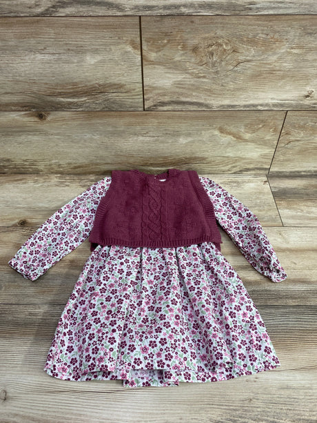 Front view of Nicole Miller floral long sleeve dress and knit vest in pink showcasing floral pattern and cable-knit front on wood-look background