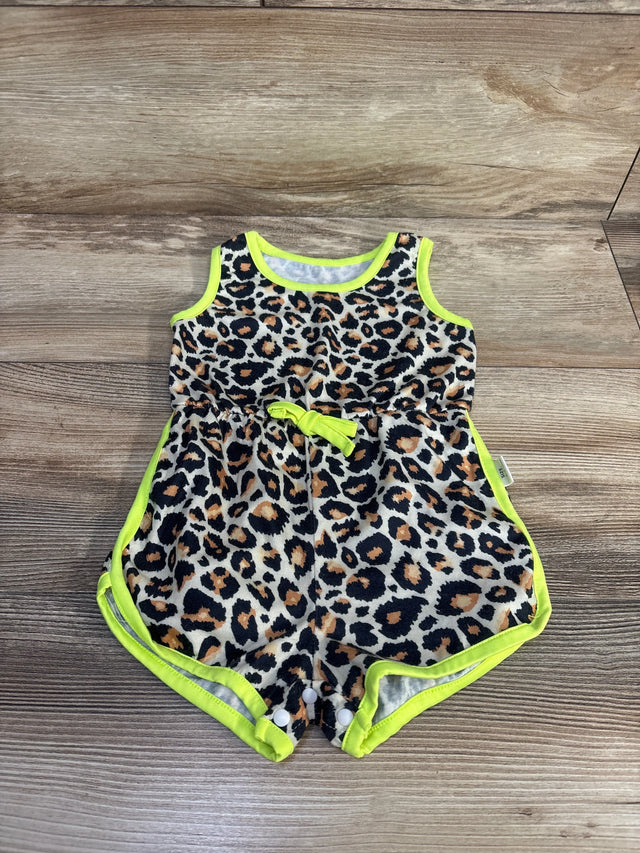 Top view of baby leopard print tank romper showcasing neon yellow trim, waist bow and snap crotch closures on wood floor