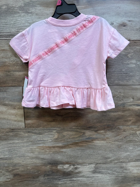 Front view of pink Disney Junior Minnie Mouse shirt with diagonal lettering and gathered ruffle hem on a hanger