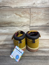Rear view of Garanimals infant brown boots showing padded dark brown collars, red plaid lining, rubber soles and attached Garanimals tag on wood backdrop
