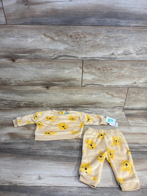 Children's two-piece beige fleece outfit with yellow bear faces, long-sleeve top and pants on wooden floor