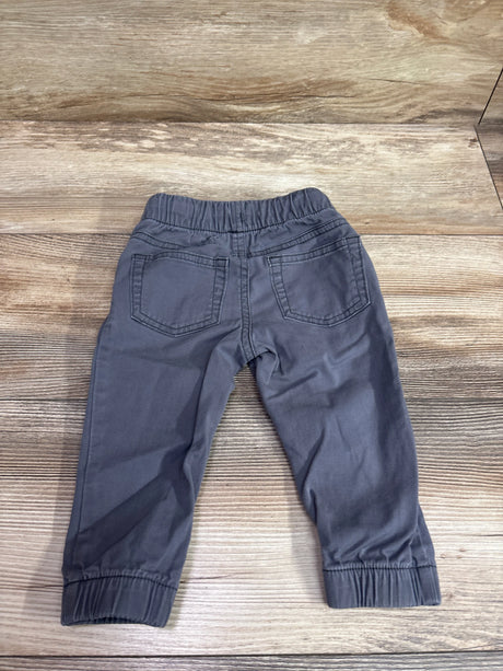 Rear view of grey Cat & Jack cotton joggers for infants size 12m on a wooden surface