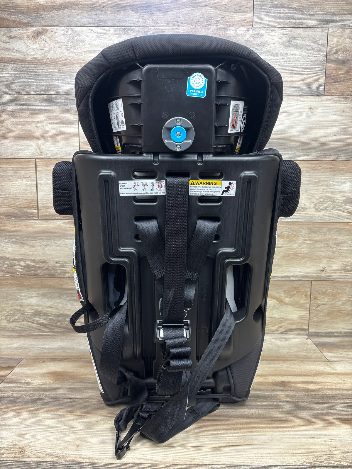 Rear view of Baby Trend Hybrid SI 3-in-1 booster car seat in Madrid Black showing harness straps and adjustment hardware
