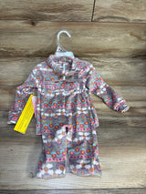Fleece toddler pajama set with rainbow and floral print on wooden background