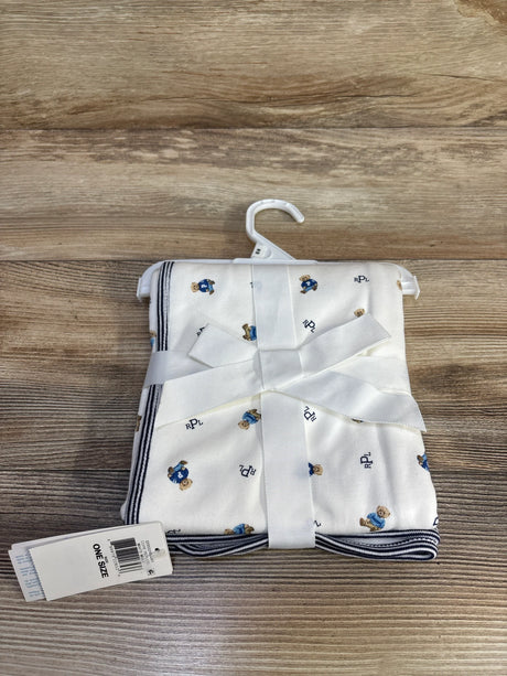 Folded view of Ralph Lauren Polo Bear cotton baby blanket showing small bear print, navy striped trim, white ribbon and ONE SIZE tag on wood surface