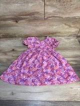 Pink and purple floral short sleeve toddler dress on wooden background