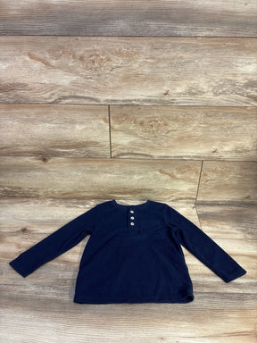 Flat lay of Cat & Jack navy waffle knit henley shirt, toddler size 3T, showcasing three-button placket, chest pocket and long sleeves on light wood background