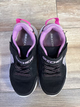 Top-down view of Skechers Ultra Flex black sneakers with purple lining and velcro strap with SKECHERS logo